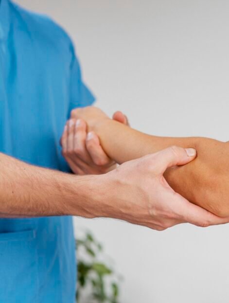 side-view-male-osteopathic-therapist-checking-female-patient-s-elbow-joint-movement.jpg