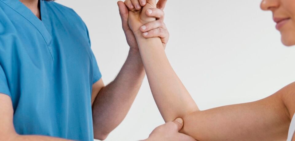 side-view-male-osteopathic-therapist-checking-female-patient-s-elbow-joint.jpg