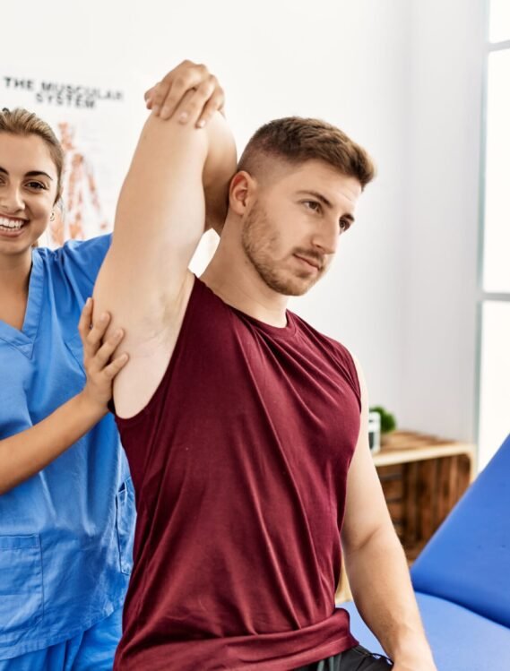 Young hispanic physioterapist woman make arm rehab treatment to man at the clinic.